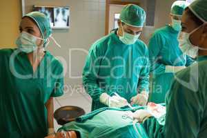 Team of surgeons working on the stomach of a patient
