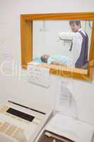 View of doctor doing a radiography through a window