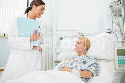 Obstetrician talking to a smiling pregnant patient