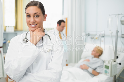 Female doctor folding her arms and holding her chin