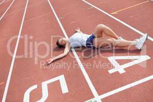 Woman taking break on track field