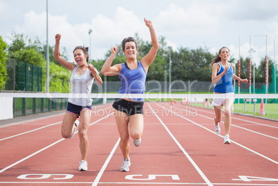Athletes celebrating as they cross finish line