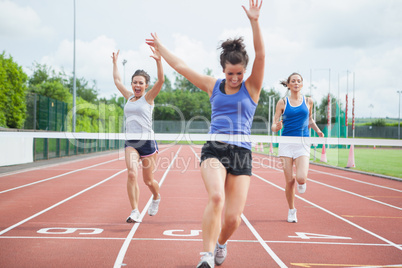 Athlete celebrates race win at finish line