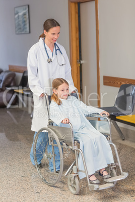 Doctor wheeling a patient in a wheelchair