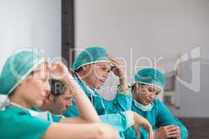 Group of sad surgeons sitting on the floor