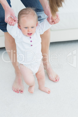 Mother helping her child to walk