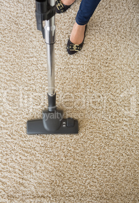 Carpet being hoovered by woman