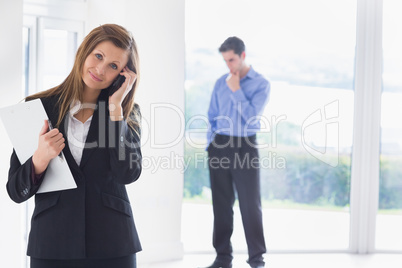 Woman calling on phone while man deciding