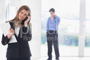 Woman calling on phone while man deciding