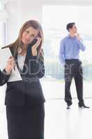 Woman calling while man looking around and deciding