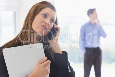 Estate agent looking disappointed on the phone