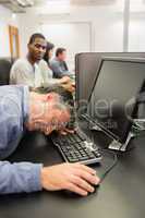 Man taking nap at computer class