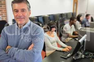 Teacher smiling at top of computer class