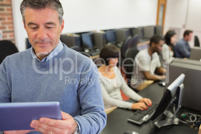 Teacher standing holding a tablet PC