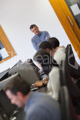 Teacher overlooking students working