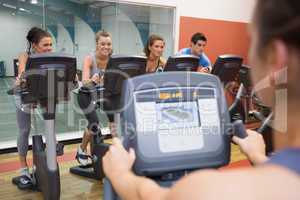 Smiling group taking spinning class