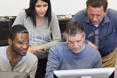 People looking at computer monitor