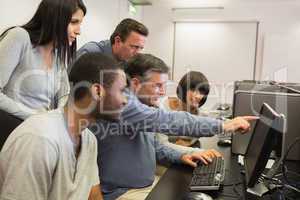 Teacher pointing at computer monitor