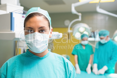 Female surgeon posing with her uniform