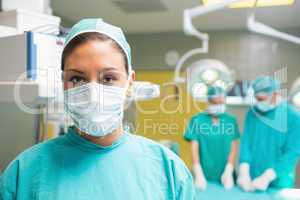 Female surgeon posing with her uniform