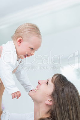 Mother holding her child while smiling