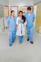 Two nurses and a doctor walking in a hallway