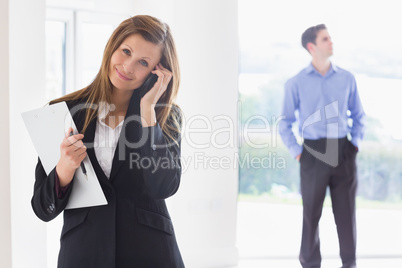 Estate agent on phone while man deciding