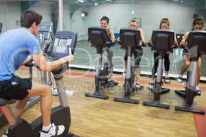 Male instructor teaches spinning class