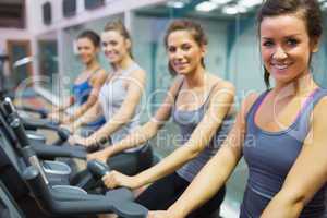 Smiling women at spinning class