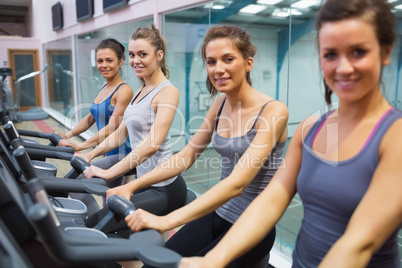 Happy women on exercise bikes