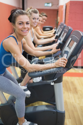 Four women on exercise bikes