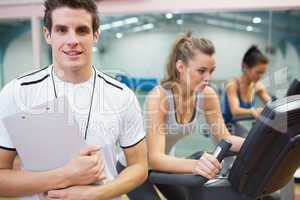 Spinning class instructor holding clipboard