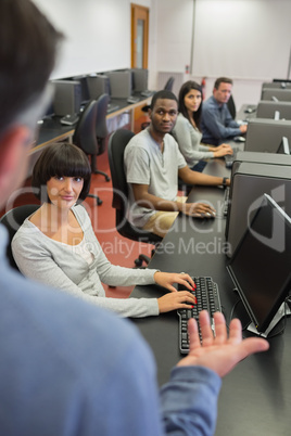 Teacher talking to the students in computer class