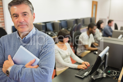 Teacher standing while holding a tablet PC