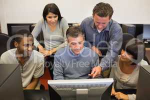 Students looking at computer