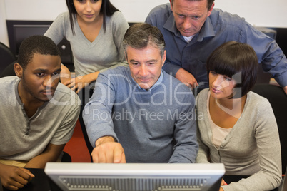 Man pointing out something on computer monitor