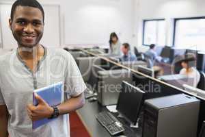 Student in computer room holding tablet pc