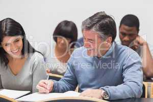 Man and woman talking during lecture