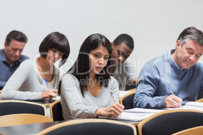 Students taking notes in lecture