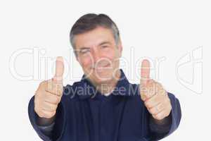 Male mechanic gesturing thumbs up