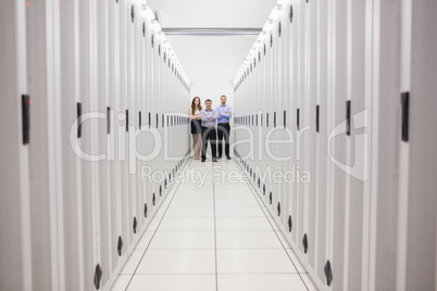 People standing in corridor of data center