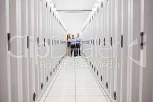 People standing in corridor of data center