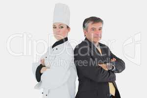 Businessman and chef standing back to back