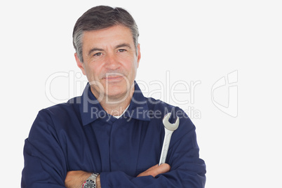 Confident male mechanic with wrench