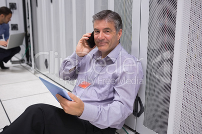 Technician phoning on the floor with digital tablet