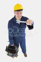 Mature mechanic with spanner carrying tool bag
