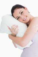 Smiling woman waking up on her pillow