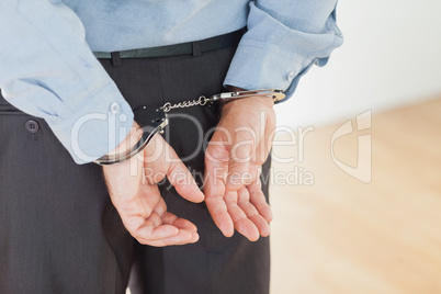 Hands of businessman with handcuffs