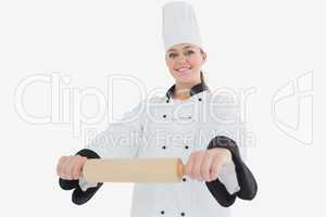 Happy female chef with rolling pin