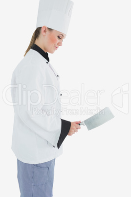 Chef holding meat cleaver as she smiles